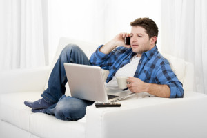 relaxed man with computer talking on mobile
